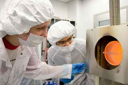 Two research scientists in lab outfits