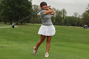 Golfer hitting a ball.