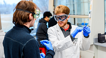 Students looking at test tube