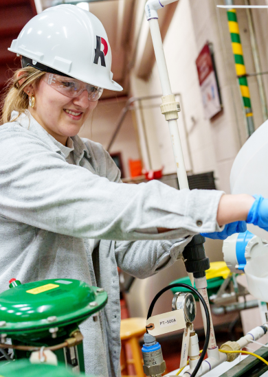 Female student works in chemical engineering lab.