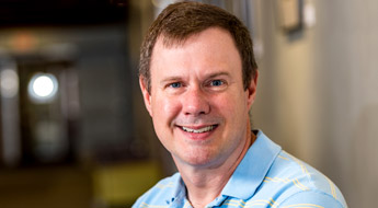 !A smiling Dr. Dan Morris standing in the hallway at Rose-Hulman