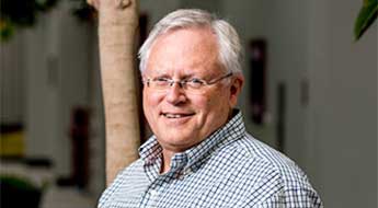 !Don Richards smiling and standing outdoors on the Rose-Hulman campus.