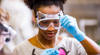 Female student dispenses liquid with a dropper.