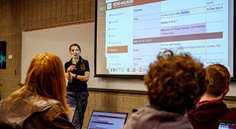 Image of instructor teaching students in classroom.