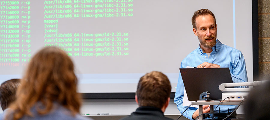 Student working on robot with professor