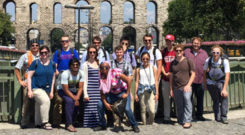 !Rose-Hulman study abroad group posing outside the coliseum in Rome.