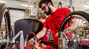 Male student works on high-efficiency vehicle