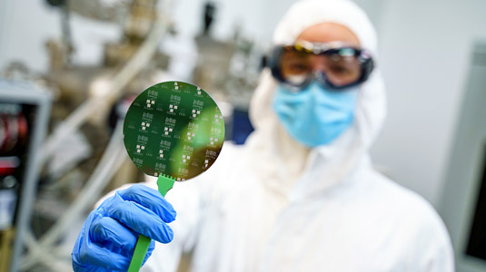 Man holding disc in MiNDS lab.