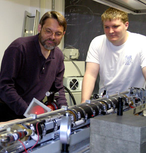 Dr. Bunch and student work in physics lab.