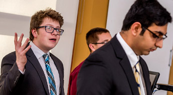 Male students participate in mock presidential debate.