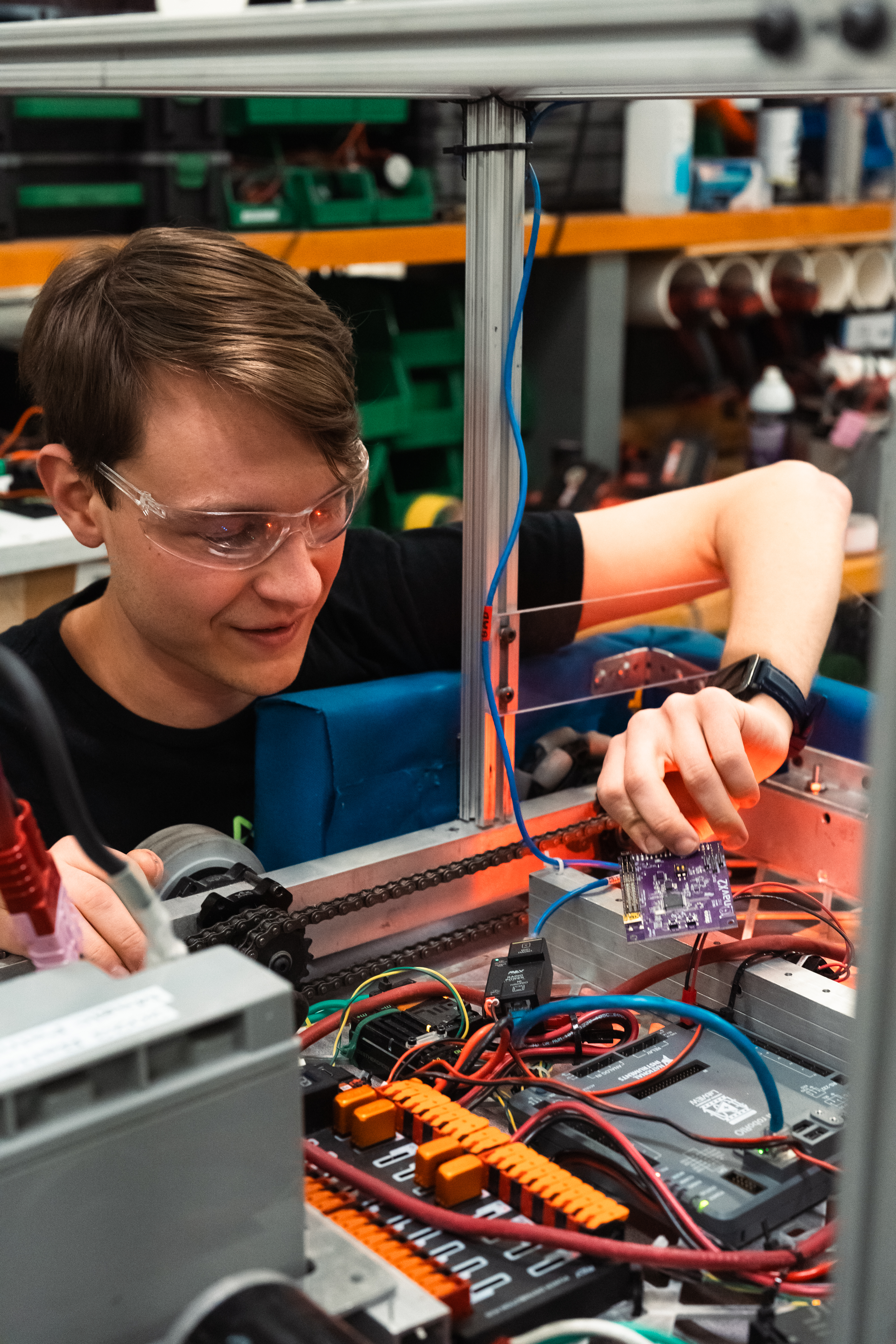 Student wires a tall robot.