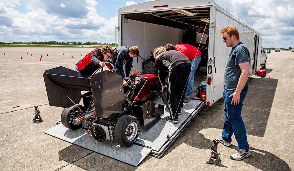 Students unloading car at airport