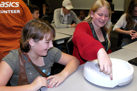 Students test the reactions of self-propelled robotic device.