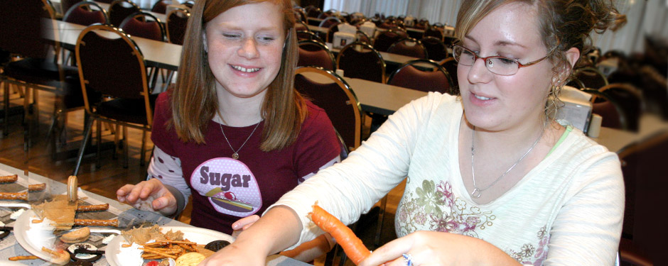 Students building cars out of food.