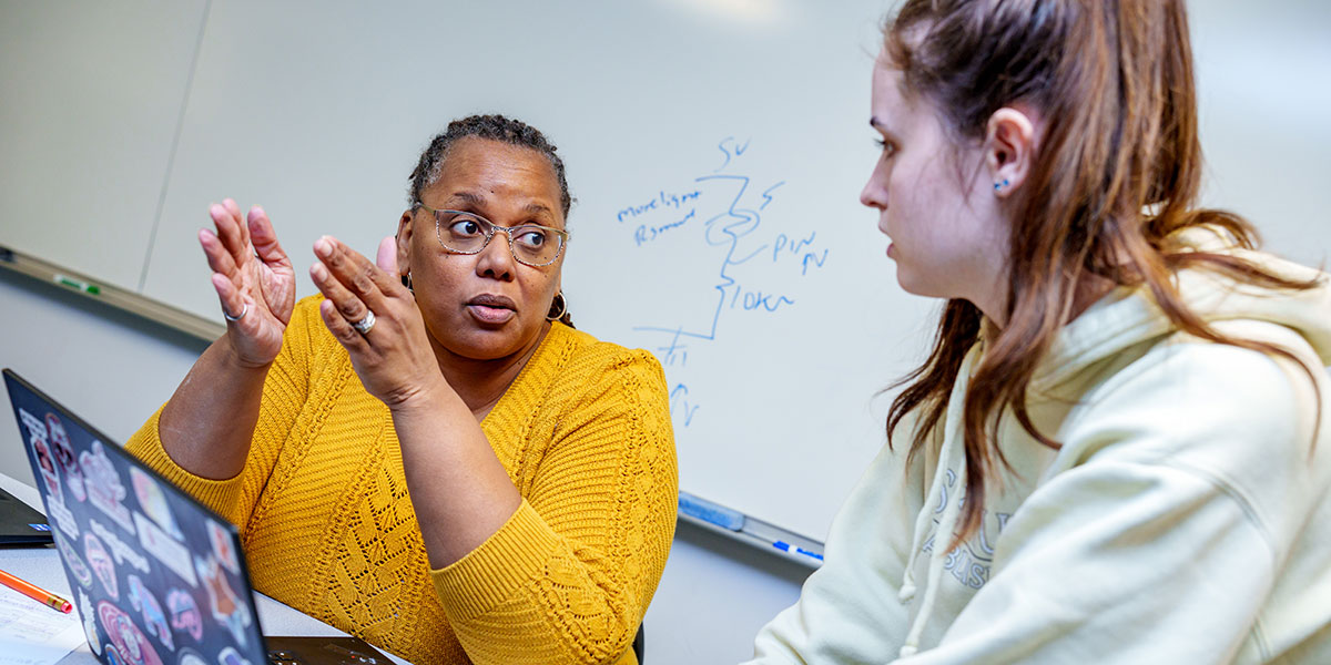 Students and faculty working in a classroom.