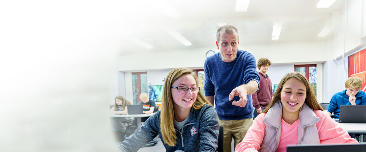 Students and faculty working together in class.