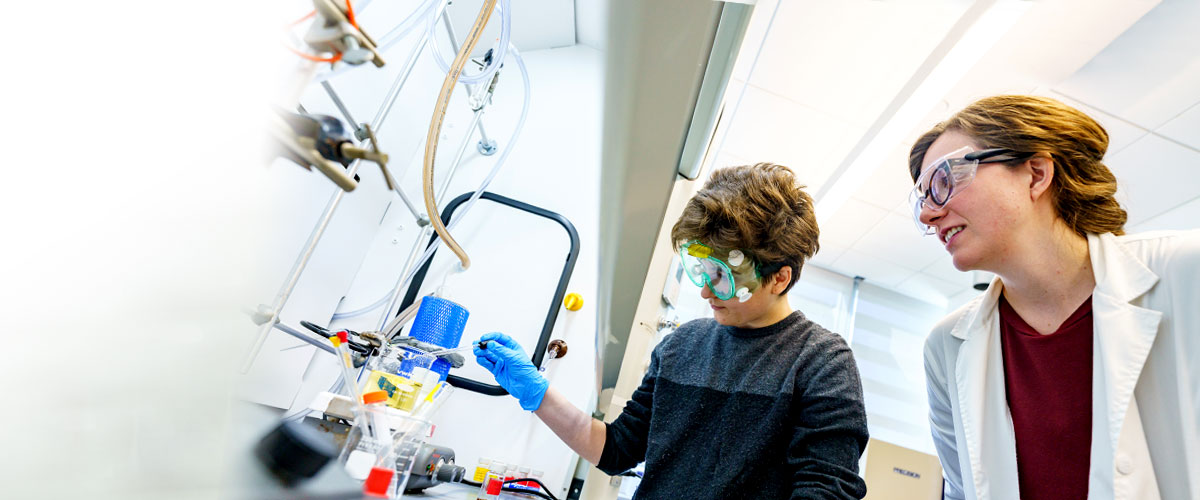 Student and faculty working in a lab.