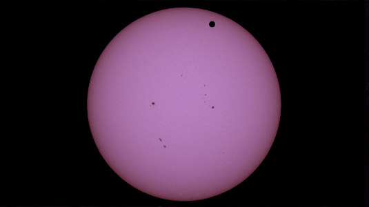 Round glowing violet-colored image of Venus