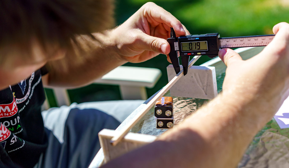 Austin Perry calculates the flexibility of a wood beam the force needed to break it.