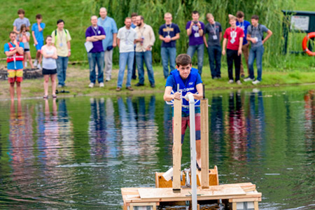 Kids working on Catapult summer project on lake