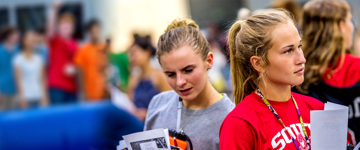 Image shows two female high school students at an information session during a Campus Visit day.