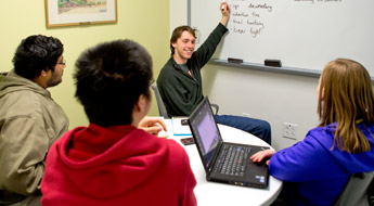 !Students listening to a tutor inside the Learning Center.