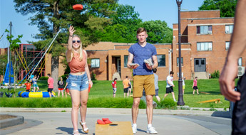 Photo of students playing corn hole at Final Friday event in May 2025. 