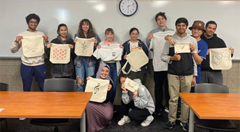 Group of smiling students holding bags