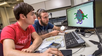 !Student holding 3D printed item