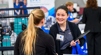 Student meets with employer at Career Fair.