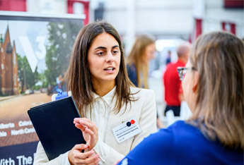 Student meets with company recruiters at Career Fair.