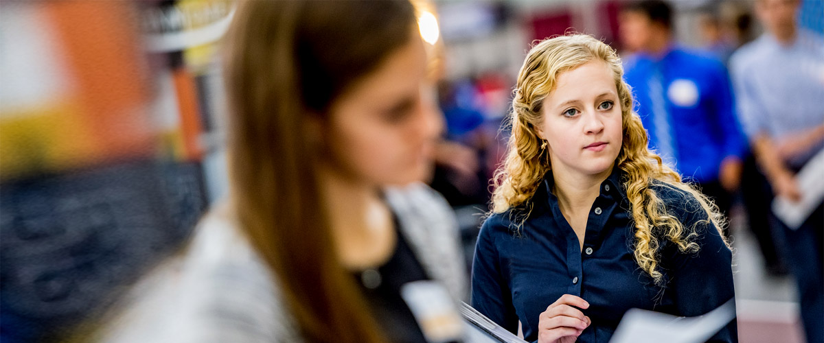 Female students preparing to meet with recruiters at the career fair.