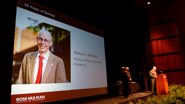 Professor Mike Moloney receiving service award on stage at Hatfield Hall