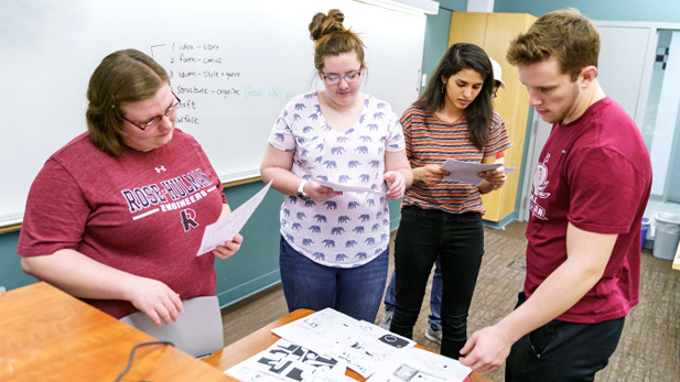 A group of students examines comics