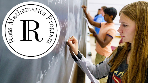 Students writing on a chalkboard.