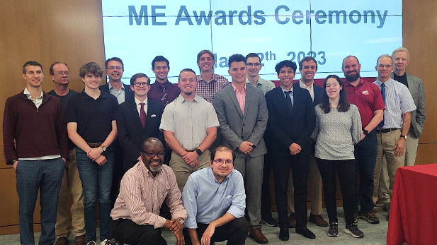 A group of students and faculty pose for a photo.