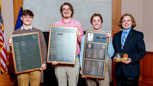 Rose-Hulman students holding awards for physics and optical engineering.