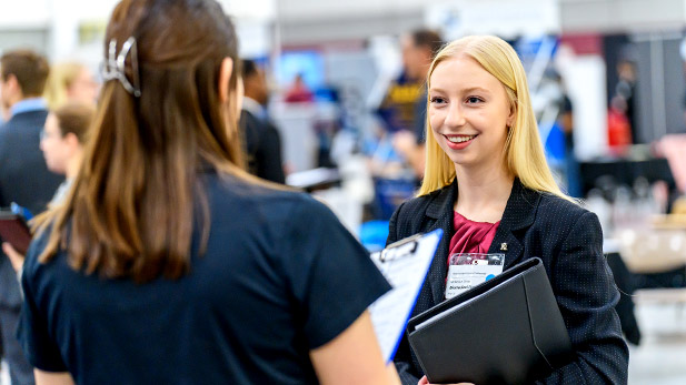 A student talks to a recruiter at Rose-Hulman's winter career fair.