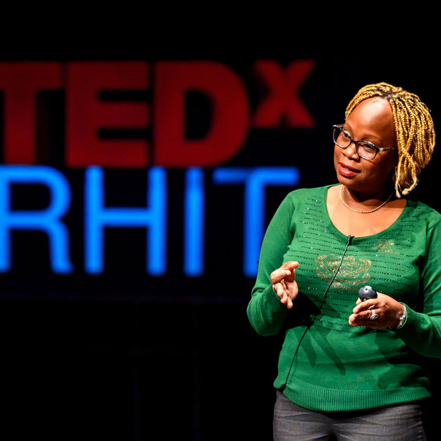 Carlotta Berry speaks on the TedxRHIT stage.