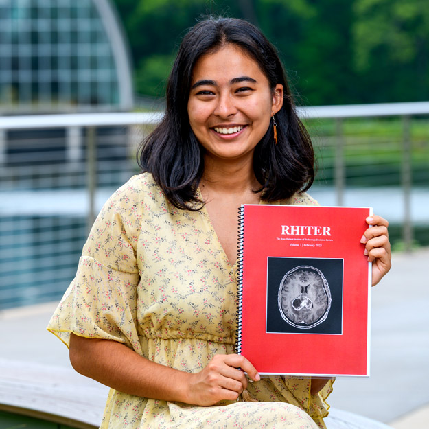 Rose-Hulman student Gillian Gorocica holds up her published journal.
