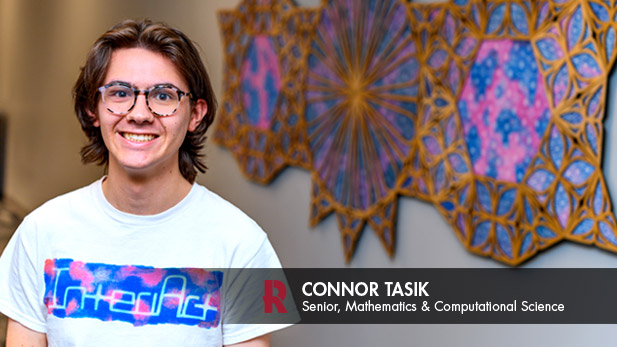 Connor Tasik is smiling at new art installation in Moench Hall.