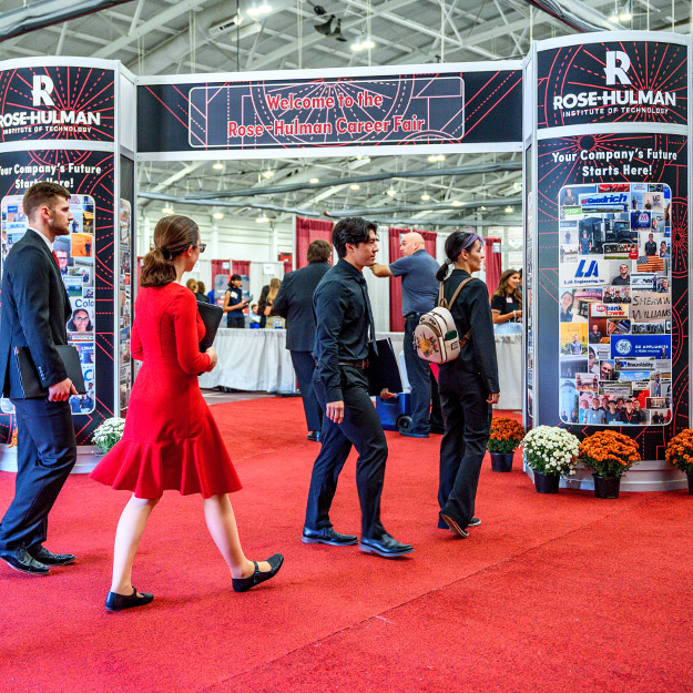 A female student speaks with a recruiter during the Fall Career Fair 2025, engaging in networking and exploring job opportunities.