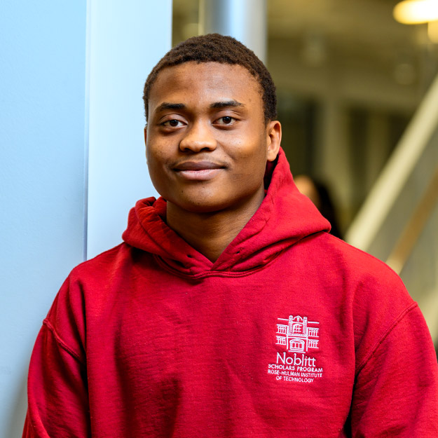 Fredrick Odezugo wearing a Noblitt Scholars Program Sweatshirt in the Fowler Academic Building.