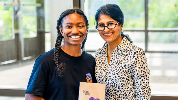Jayshree Seth and the student, Janae Gillus, holding the book.