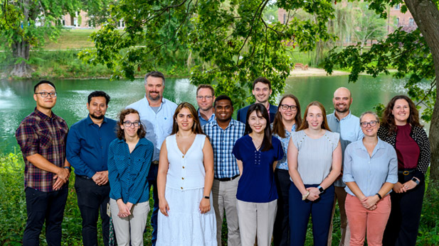New faculty standing by Speed Lake in summer.