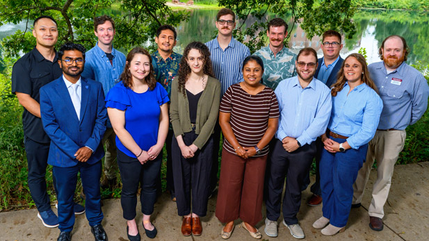 New faculty standing by Speed Lake in summer.