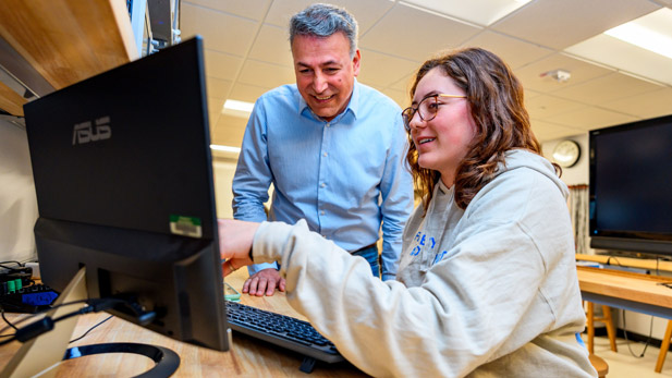 Rose-Hulman faculty and a student work together at a computer station.