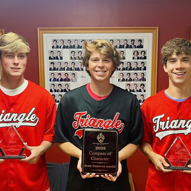 Jansen Biddle, William Wittich, and Andrew Cameron hold their awards while wearing Triangle shirts.