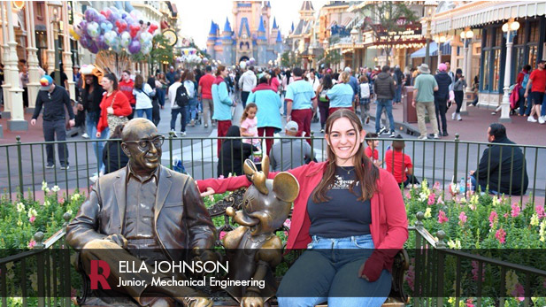 Ella Johnson sits on a bench with a statue of Minnie Mouse and Roy Disney in Walt Disney World's Magic Kingdom on Main Street, U.S.A.