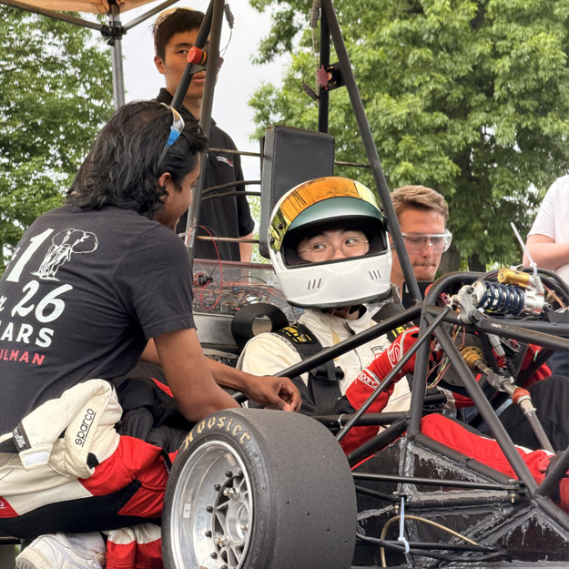 Rose Grand Prix Engineering team with their racecar chassis.